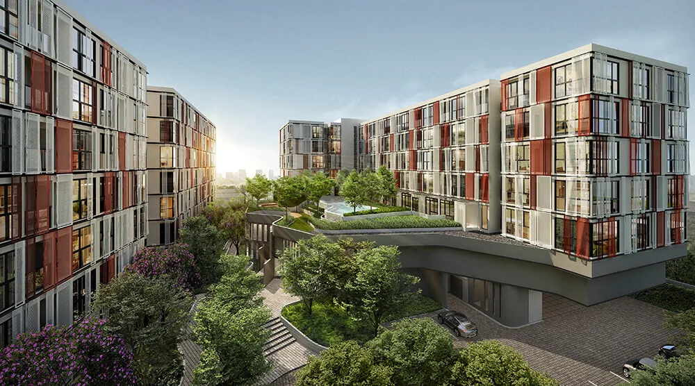 Modern apartment buildings with colorful facades, surrounded by lush greenery, set against a clear sky.