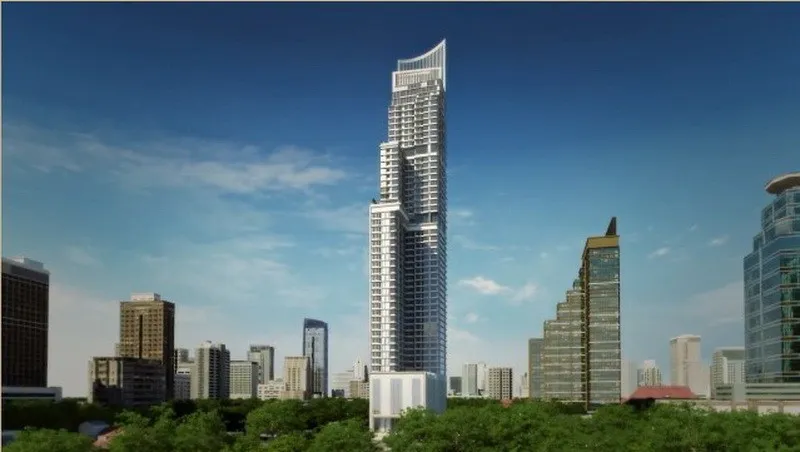 高耸的现代摩天大楼，周围环绕着其他建筑和绿地，头顶是蓝天。