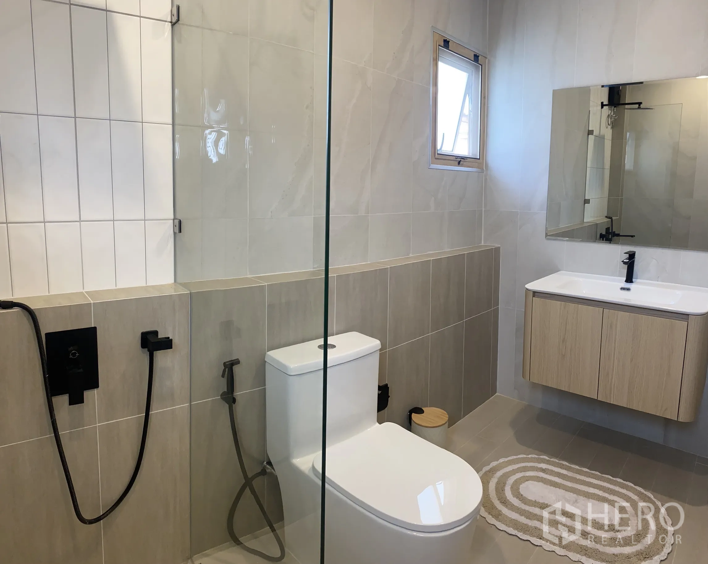 Detached House for sale in Suan Luang, Bangkok - Bathroom with glass shower screen, floating vanity and black hardware.