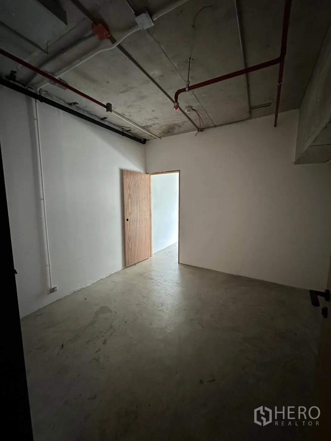 Retail Space for rent in Watthana, Bangkok - Windowless utility room with concrete floor and visible ceiling services.