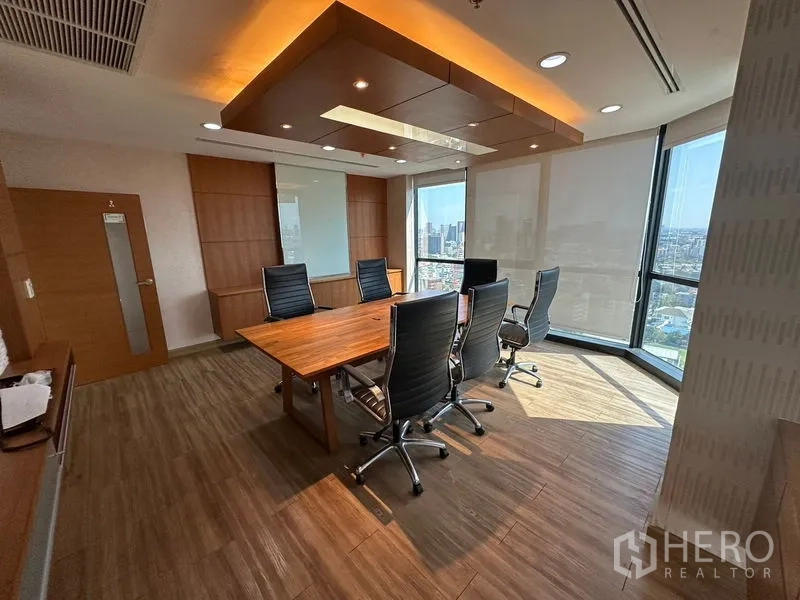 Office Space for rent or sale - Rectangular meeting room with wooden table, city views and feature ceiling.