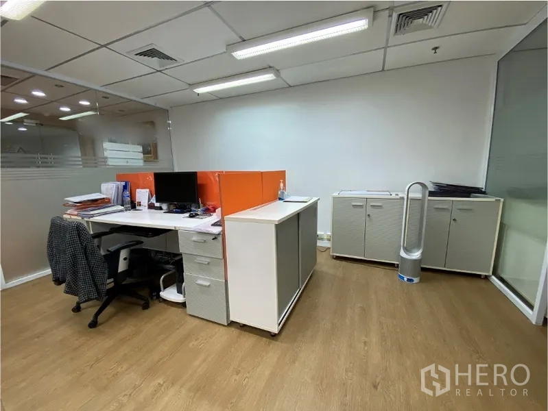 Office Space for rent in Khlong Toei, Bangkok - Private workstation with desk and orange divider, storage cabinets and glass partition.