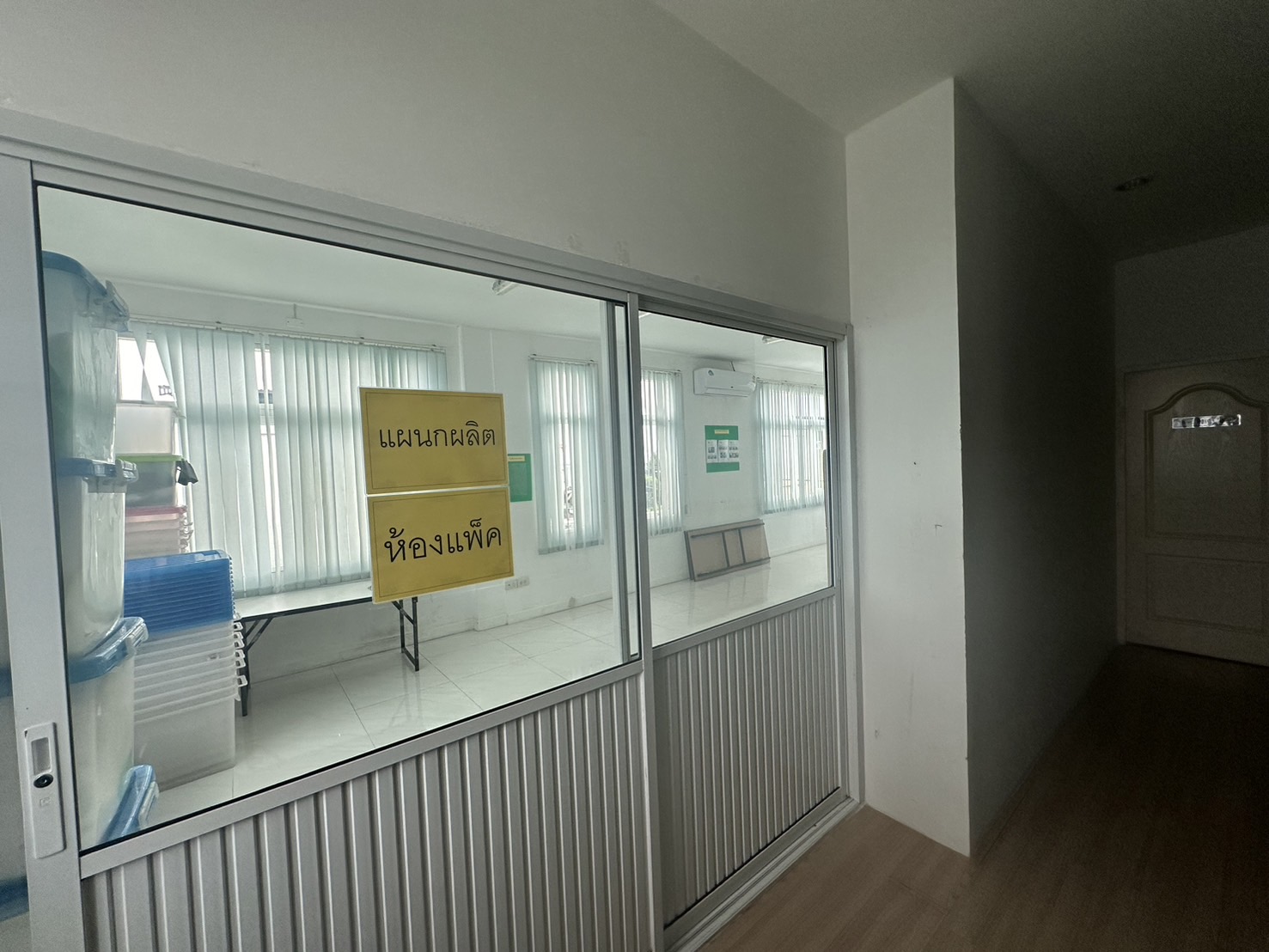Warehouse for rent or sale in Lam Luk Ka, Pathum Thani - Glass-partitioned packing room beside an internal office corridor.