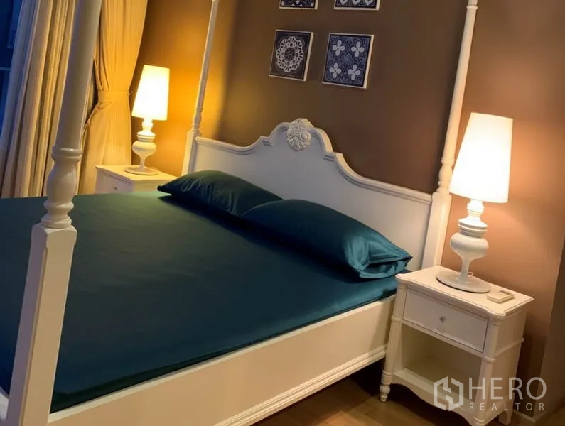 Condominium for rent in Watthana, Bangkok - Elegant bedroom featuring a white four-poster bed, matching nightstands and bedside lamps.