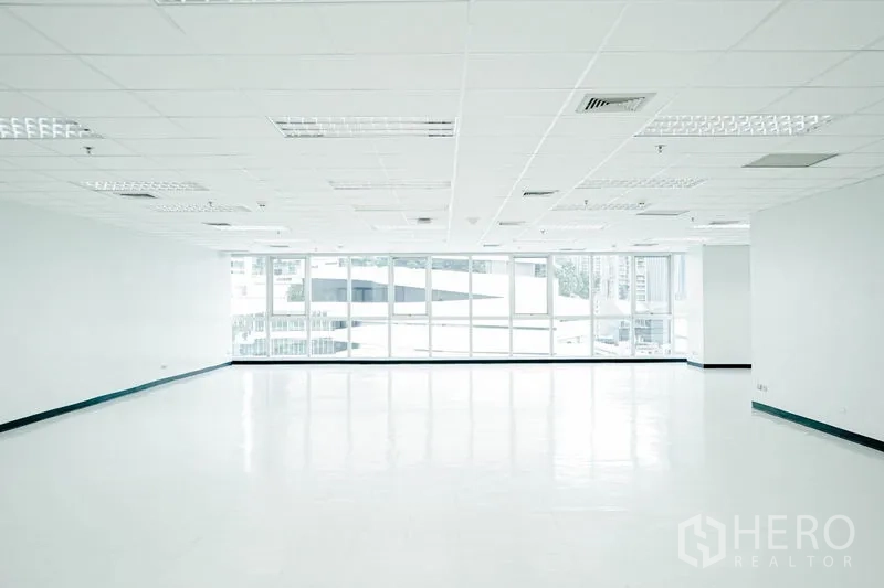 Office Space for rent in Watthana, Bangkok - Large white office facing wide windows that flood the room with daylight.