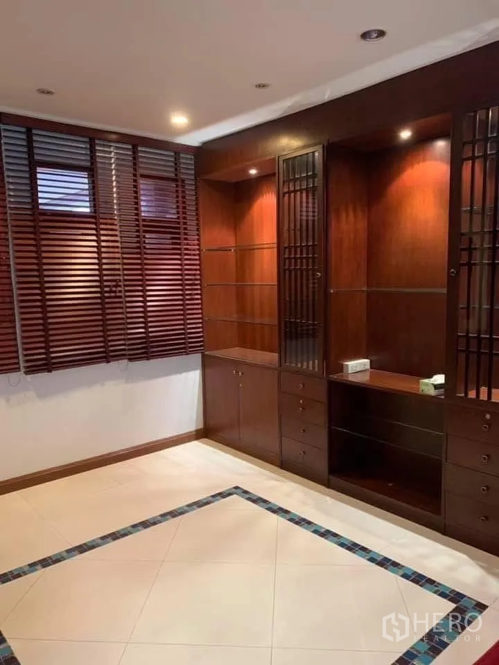 Townhouse for rent in Watthana, Bangkok - Room featuring built-in wooden cabinetry, tiled floor and window blinds.