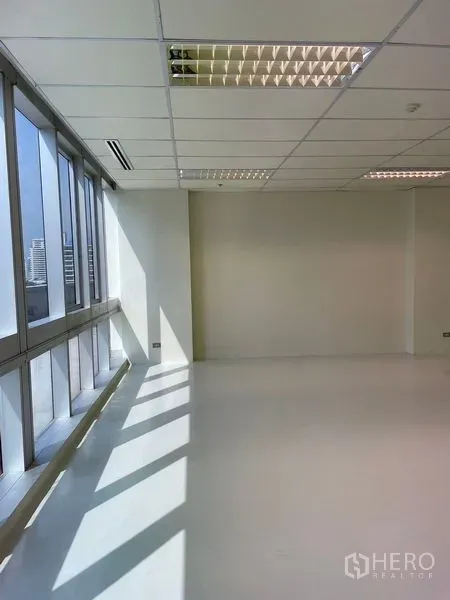 Office Space for rent in Watthana, Bangkok - Corner workspace with wide windows, abundant natural light, and skyline views.