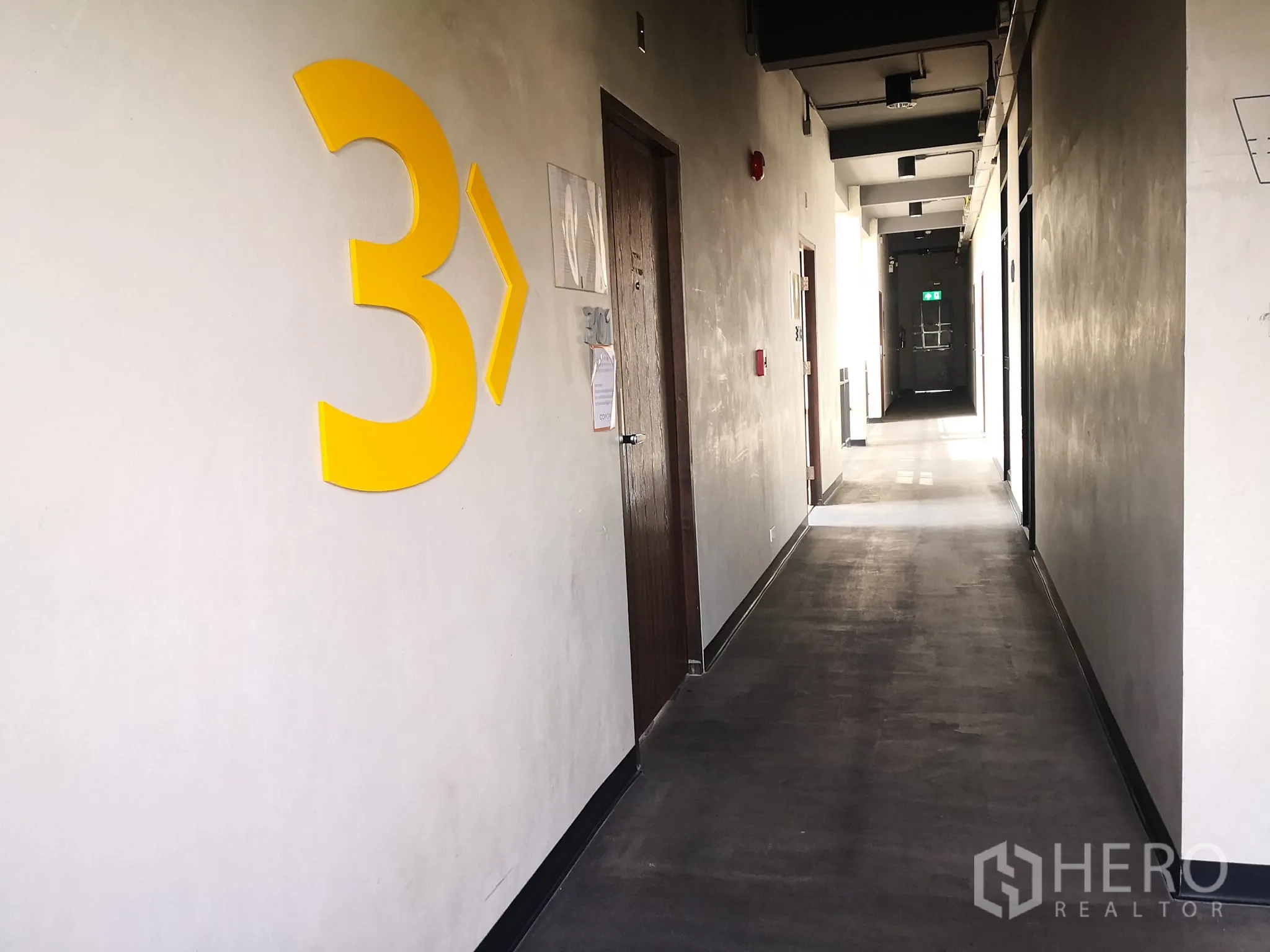Office Space for rent in Phra Khanong, Bangkok - Third-floor corridor with large yellow number 3, doors along an industrial-finish hallway