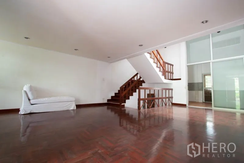Townhouse for rent in Khlong Toei, Bangkok - Large open-plan living area showing glass sliding partition to the kitchen.