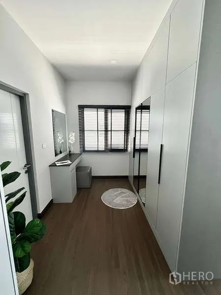 Detached House for rent in Bang Phli, Samut Prakan - Walk-in closet corridor with full-height wardrobes, vanity and window blinds.