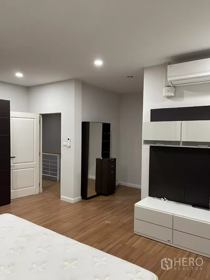 Detached House for rent in Bang Kapi, Bangkok - Master suite view showing doorway to hall and wide wood floors.