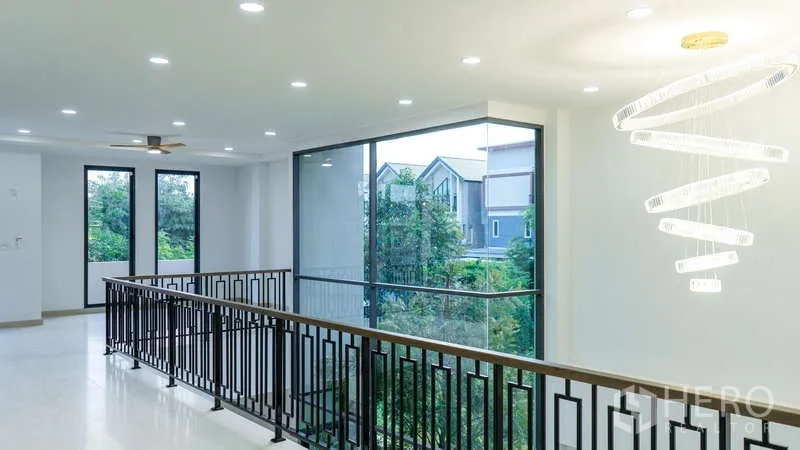 Detached House for rent or sale in Suan Luang, Bangkok - Upper hallway with a contemporary spiral chandelier and green outlook