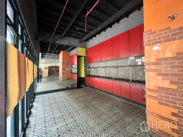 Retail Space for rent in Watthana, Bangkok - Front area with decorative floor tiles, red wall cabinets and large window glazing.