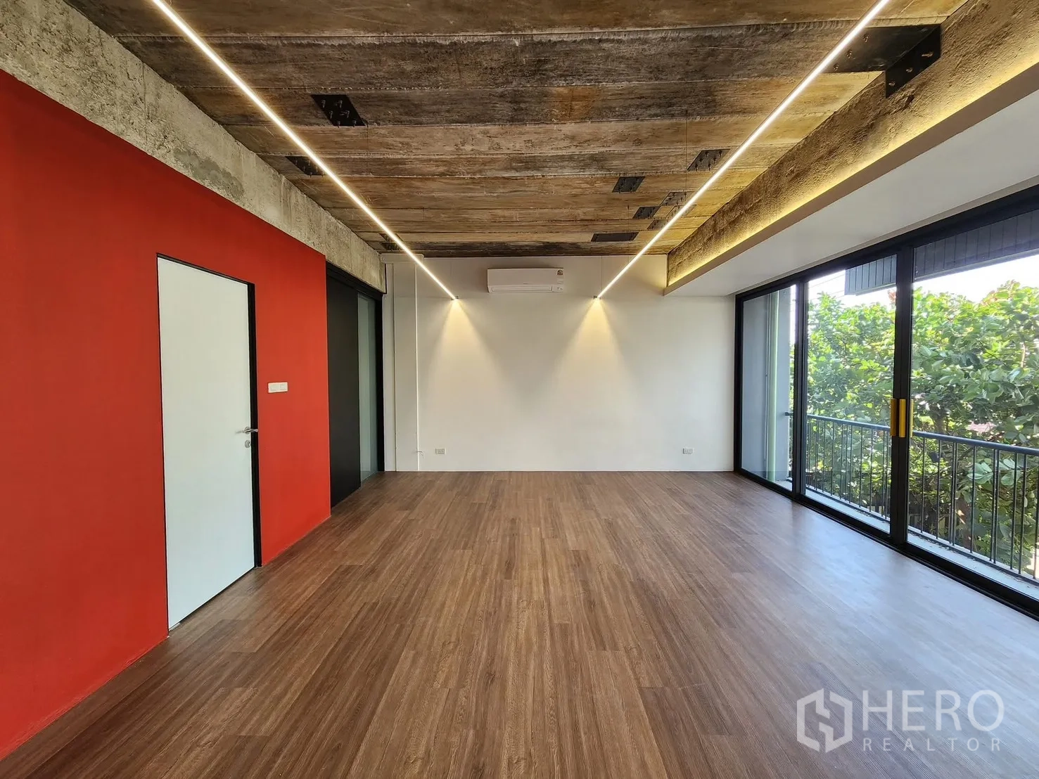 Home Office for rent in Chatuchak, Bangkok - Office room with red feature wall, ceiling strip lighting, and balcony access.