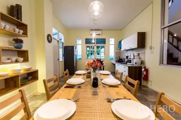 Home Office for rent in Suan Luang, Bangkok - Bright dining room with an eight-seat wooden table and pendant light.
