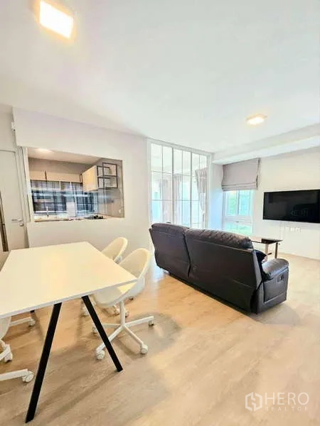 Detached House for rent or sale in Prawet, Bangkok - Glass-partition sunroom or home office with two lounge chairs and curtains.