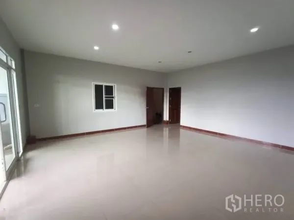 Factory for rent or sale in Mueang Samut Sakhon, Samut Sakhon - Bright ground-floor office with tiled floors, recessed lighting and glass doors.