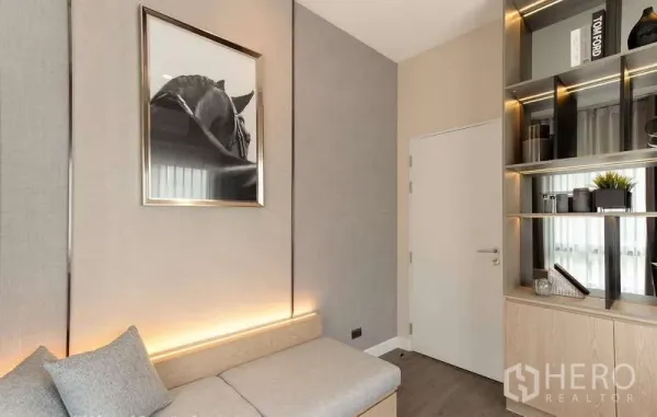 Detached House for rent in Bang Phli, Samut Prakan - Compact study or lounge with built‑in bench seating, backlit shelving and framed artwork.
