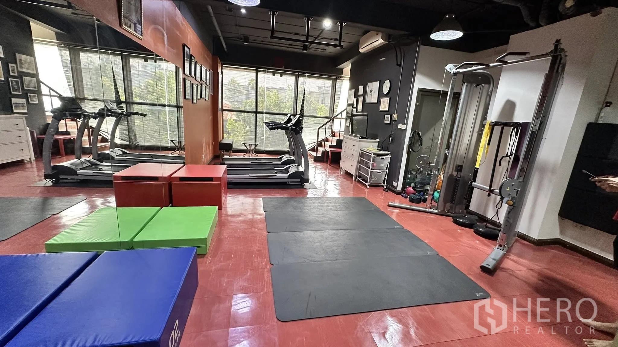 Office Space for rent in Huai Khwang, Bangkok - Fitness studio area with treadmills by large windows, mirrors, and a weight machine.