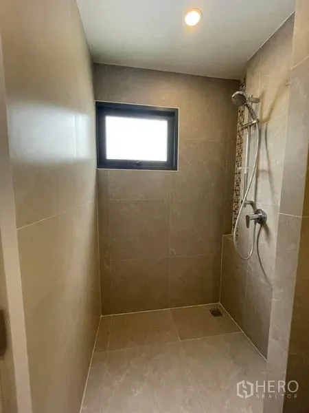 Townhouse for rent in Prawet, Bangkok - Walk-in shower area with handheld shower and a small frosted window for ventilation.