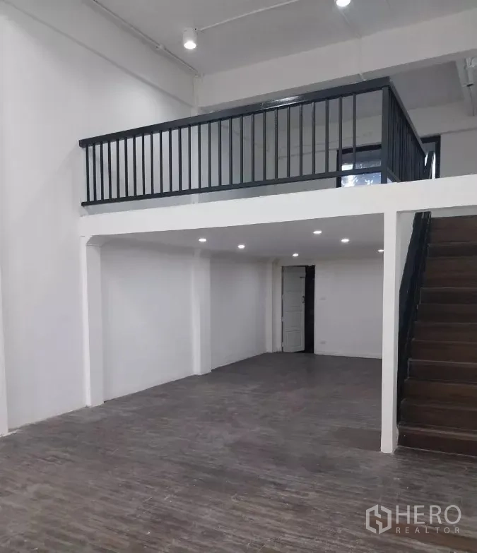 Retail Space for rent in Watthana, Bangkok - Double-height retail interior showing mezzanine, staircase, and open floor.