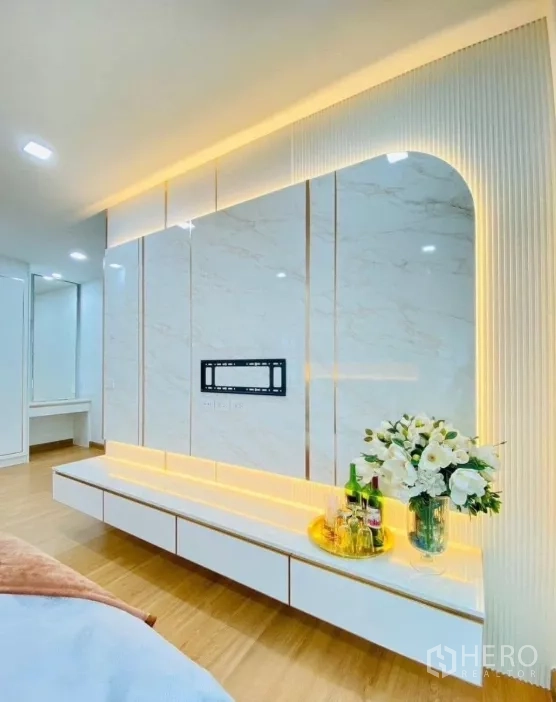 Detached House for rent in Prawet, Bangkok - Bedroom media wall with marble-look panels, floating cabinet and accent LED lighting.