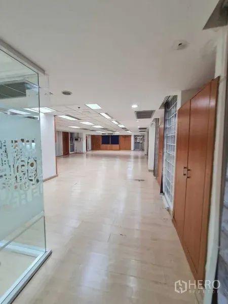 Office Space for rent in Ratchathewi, Bangkok - Long corridor to open-plan office with glass partitions, wood floors and ceiling lights.