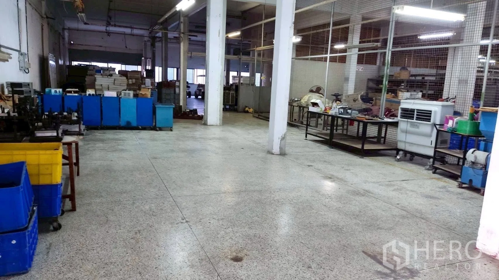 Factory for sale in Lat Krabang, Bangkok - Open workspace with plastic bins, tables, and mesh partitions across the floor.