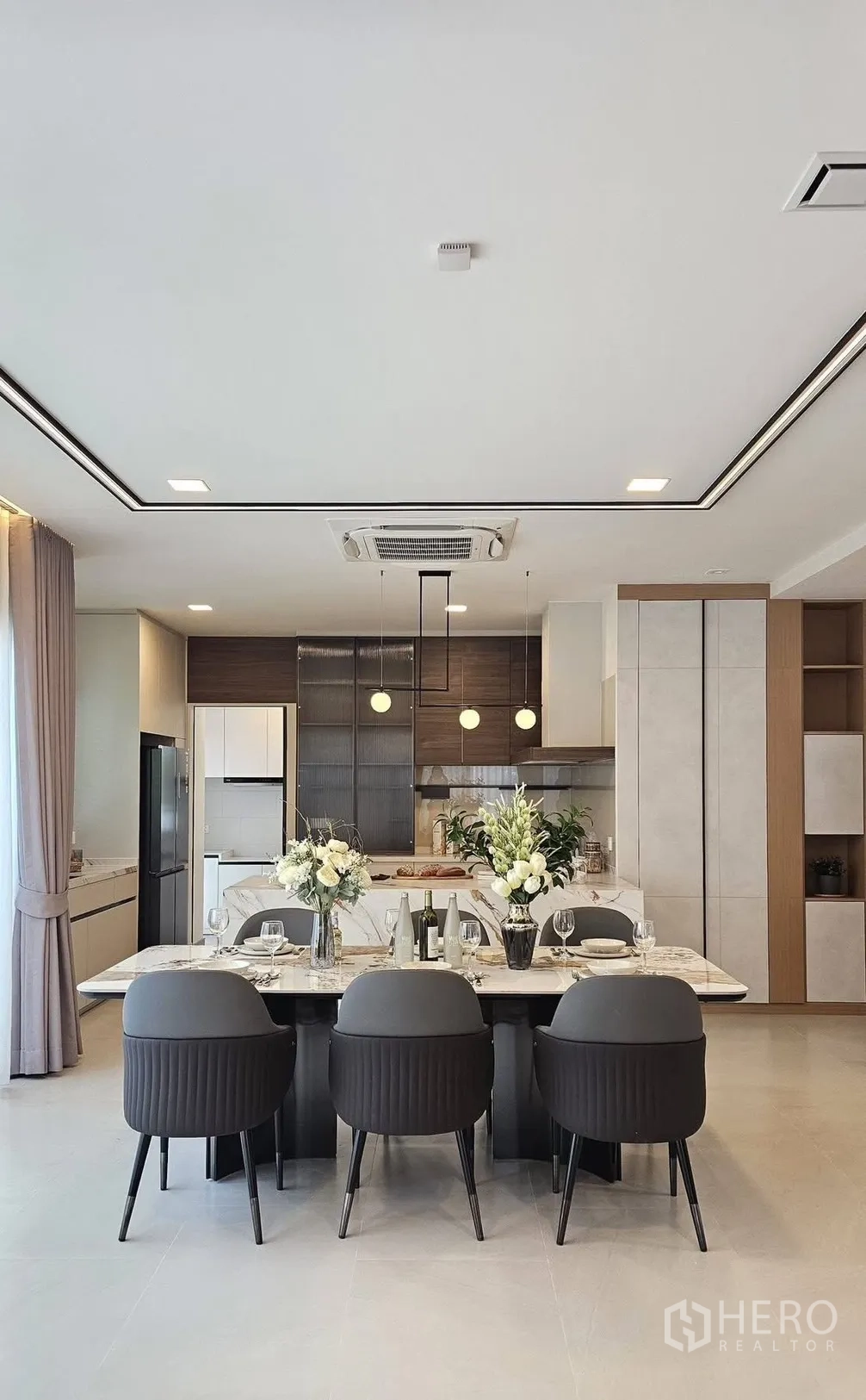 Detached House for rent in Bang Phli, Samut Prakan - Open-plan dining area with a marble table set for six and the kitchen as backdrop.