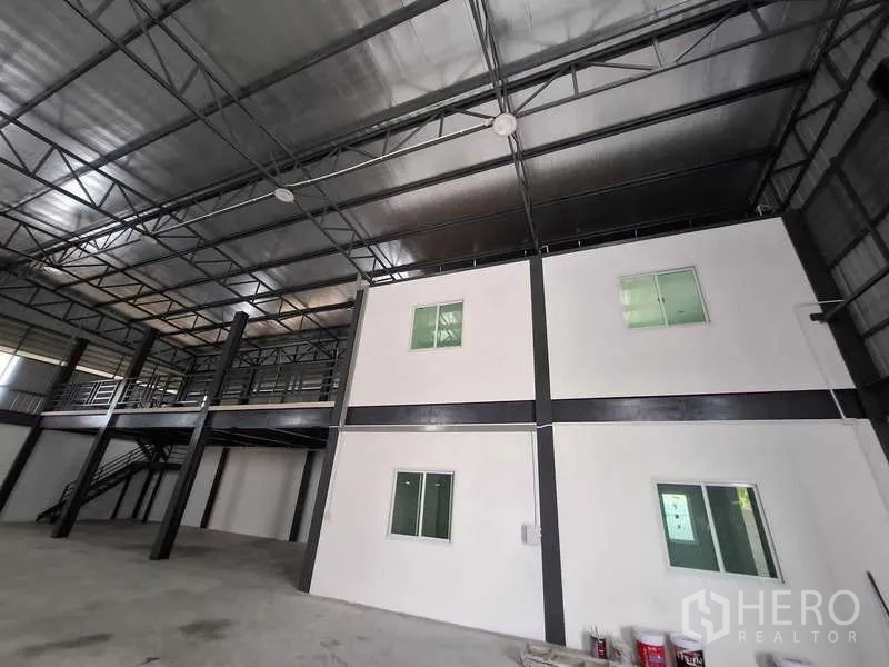Warehouse for rent or sale in Bang Phli, Samut Prakan - View of mezzanine and office structure under insulated metal roof.