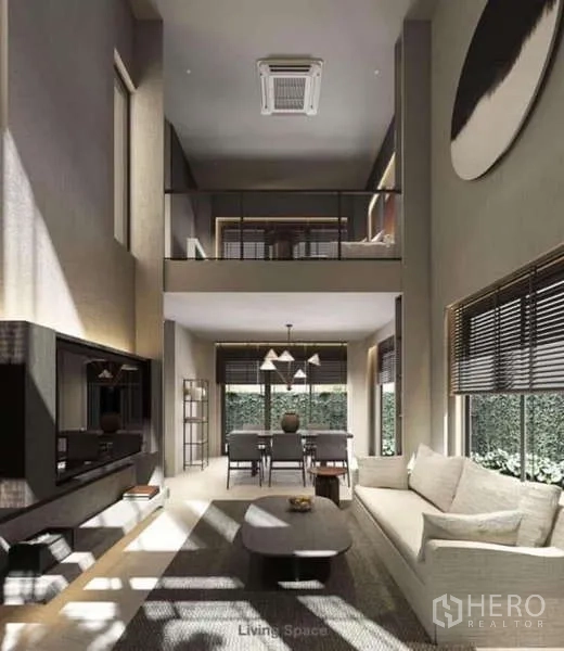 Townhouse for rent in Suan Luang, Bangkok - Double-height living and dining area with mezzanine level and full-height glazing.
