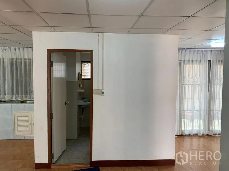 Office Space for rent in Chatuchak, Bangkok - Partition wall with door to restroom beside open-plan office area.