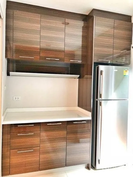 Townhouse for rent in Watthana, Bangkok - Built-in pantry cabinetry with countertop and stainless refrigerator.