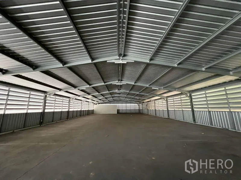 Showroom for rent - Large covered parking or storage shed with ventilated metal roofing.
