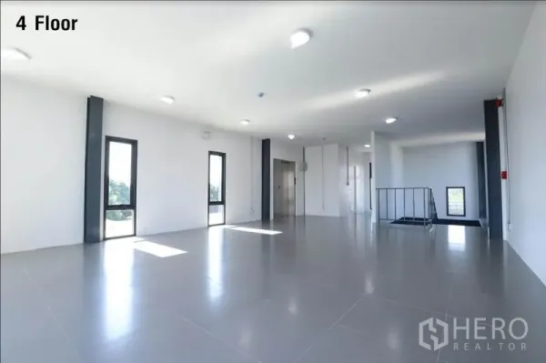 Warehouse for rent in Wang Thonglang, Bangkok - Bright fourth-floor office area with large windows and elevator access.