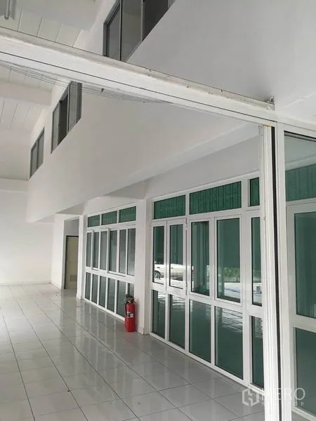 Warehouse for rent in Bang Phli, Samut Prakan - Bright glass-partitioned office area with white tiled floors inside the warehouse.