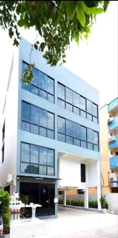 Office Space for rent or sale in Din Daeng, Bangkok - Front elevation of a contemporary office building with full-height windows.