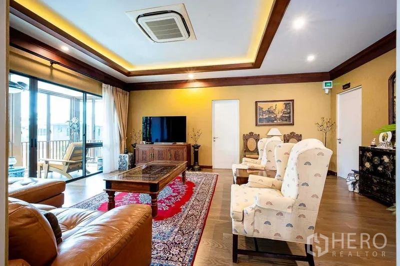 Detached House for sale in Prawet, Bangkok - Large living room with recessed ceiling lights, TV console and balcony access.