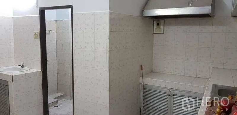 Home Office for rent or sale in Bang Na, Bangkok - Tiled pantry and bathroom area with sink, vent hood and cabinets.