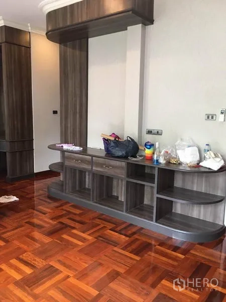 Detached House for rent in Khlong Toei, Bangkok - Bedroom corner showing built-in wardrobe and console storage in dark wood.