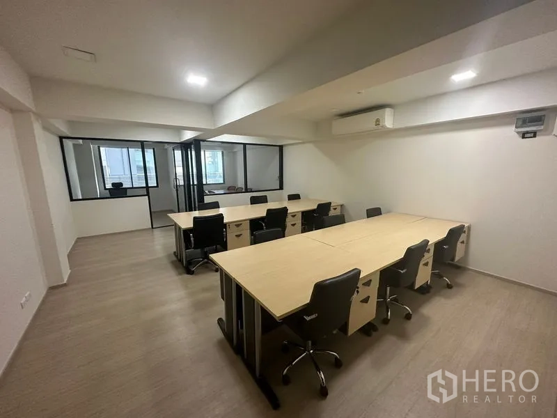 Office Space for rent in Khlong Toei, Bangkok - Open-plan office with modular desks, swivel chairs, glass-partitioned rooms and air conditioning.