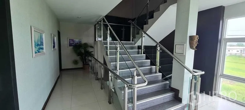 Warehouse for rent or sale in Bang Phli, Samut Prakan - Staircase with stainless-steel handrails and large window bringing in natural light.