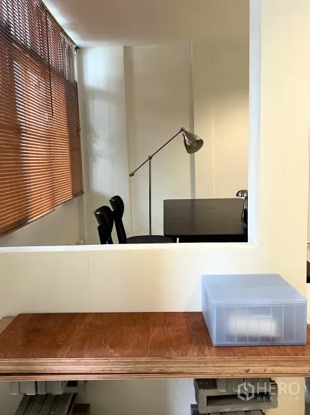 Townhouse for rent - Built‑in serving ledge and study nook with a desk lamp beside wide window blinds.