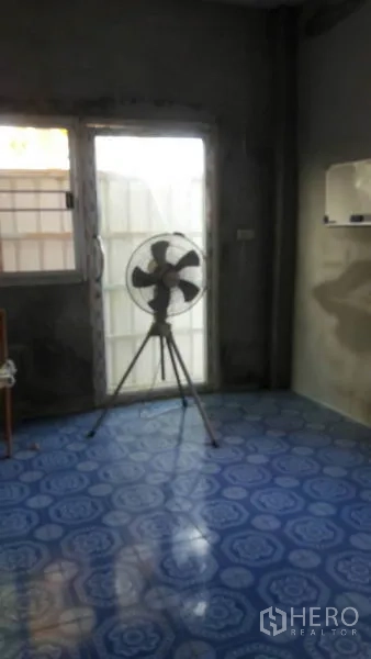 Warehouse for sale in Pathum Thani - Small office room with blue tiled floor and glass door inside the warehouse.