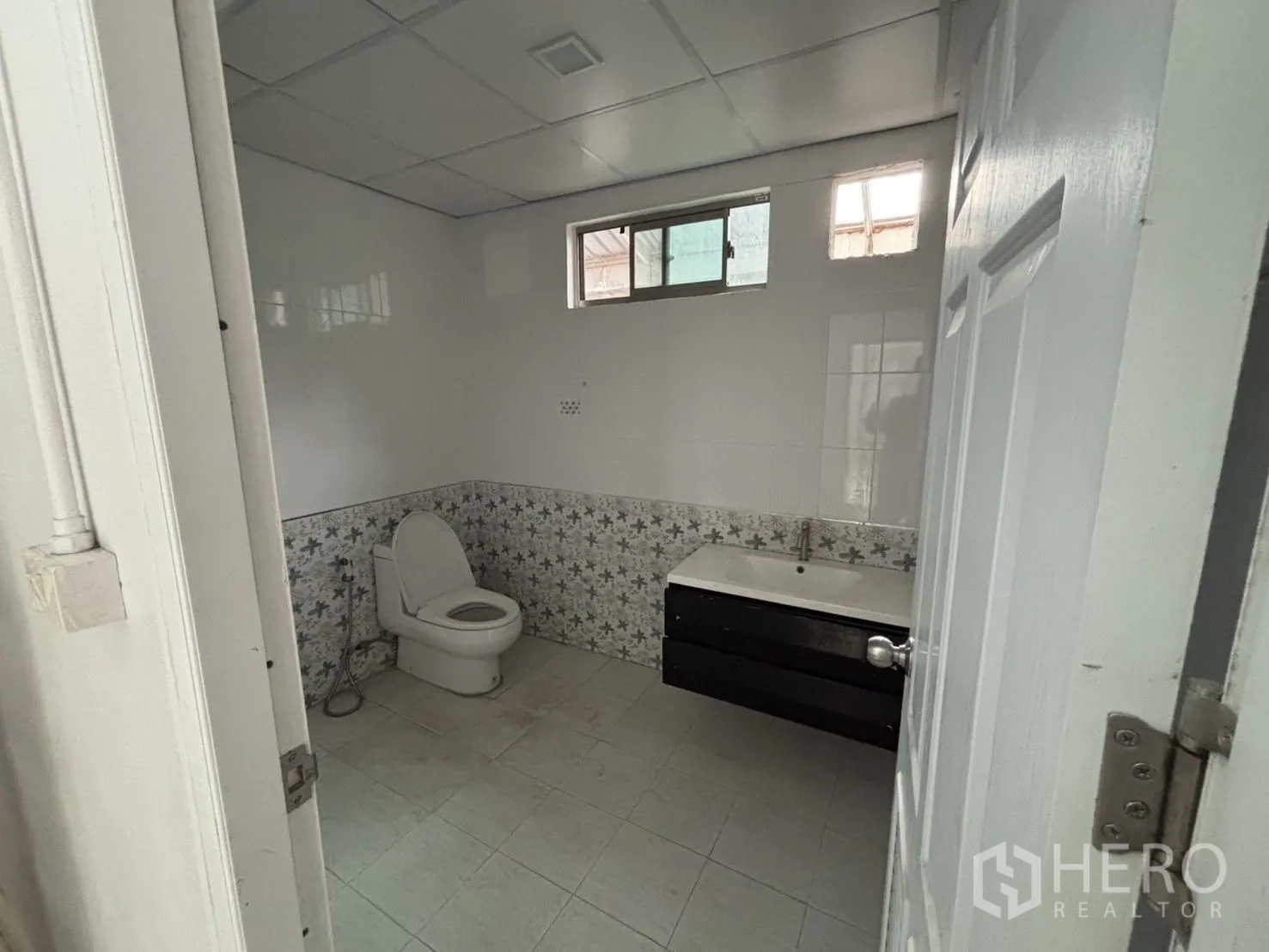 Warehouse for rent or sale in Wang Thonglang, Bangkok - Tiled bathroom with toilet and basin.