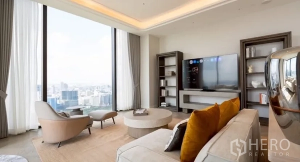 Condominium for rent or sale in Pathum Wan, Bangkok - Bright living room with TV wall, shelving and lounge seating facing skyline views through tall windows.