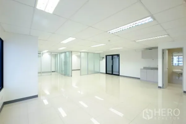 Office Space for rent in Chatuchak, Bangkok - Wide office floor with frosted-glass meeting rooms, pantry and private restroom entrance.