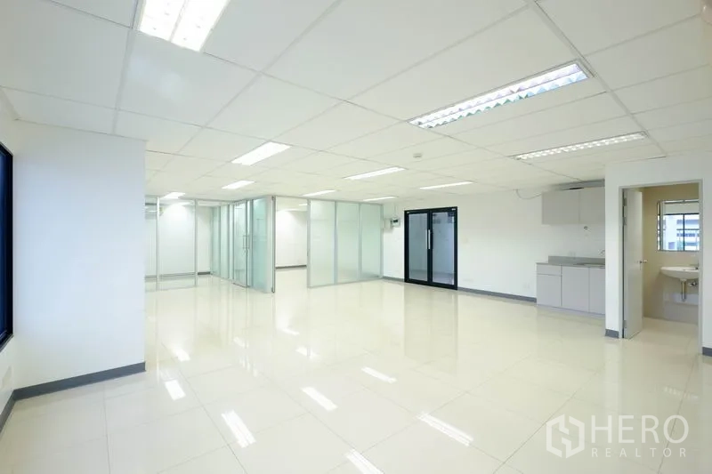 Office Space for rent in Chatuchak, Bangkok - Wide office floor with frosted-glass meeting rooms, pantry and private restroom entrance.