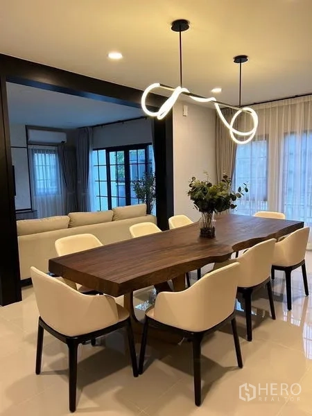 Detached House for rent or sale in Bang Phli, Samut Prakan - Alternate view of the dining area with statement pendant and sheer curtains.