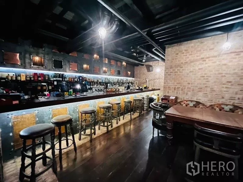 Retail Space for rent in Watthana, Bangkok - Long bar counter with stools, exposed brick walls, pendant lights and wood flooring in a two-storey venue.